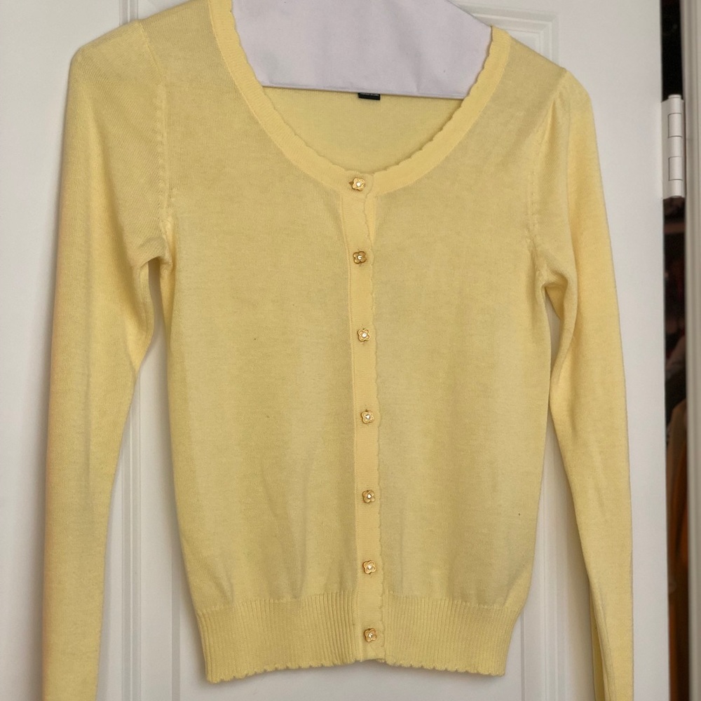 Yellow sweater with flower buttons